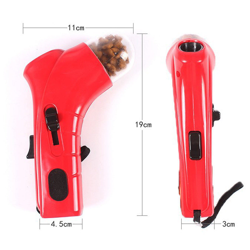 Red pet treat launcher for dogs and cats with a comfortable grip and wrist strap, spring-loaded trigger, and portable design measuring 19cm by 11cm by 3cm.