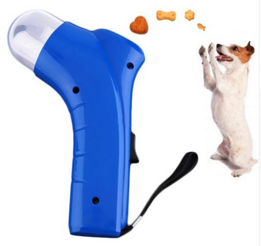 Blue pet treat launcher toy with wrist strap and treats launching towards a jumping dog