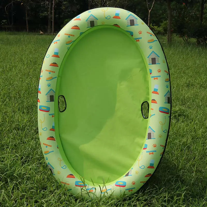 Inflatable dog swimming pool hammock for pets in a green color on grass.