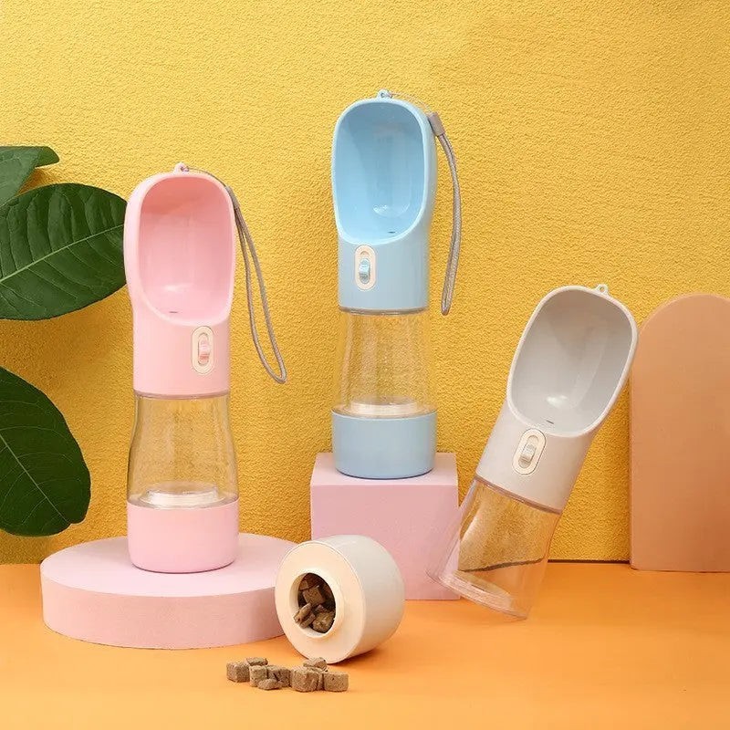 Portable pet dog water bottle with built-in drinking bowl in pink, blue, and grey colors for outdoor travel.