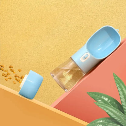 Portable blue pet dog water bottle with built-in drinking bowl and food container for outdoor travel